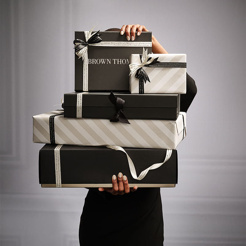 woman holding gift wrapped presents