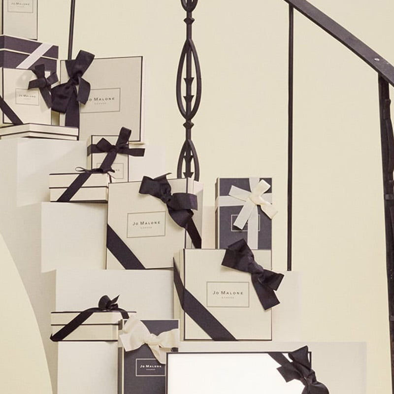 multiple Jo Malone gift boxes on a staircase