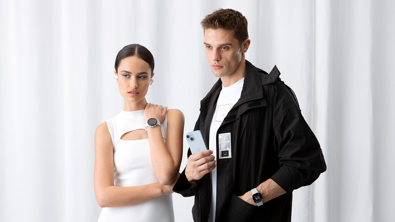 model wearing headphones and holding tech products