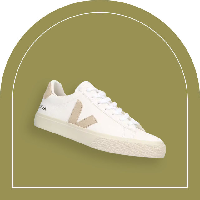 white Veja shoes over a green background