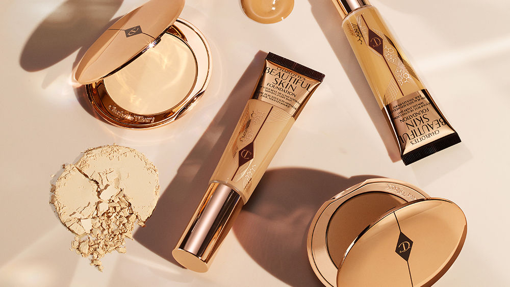 Charlotte Tilbury foundation products on gold background