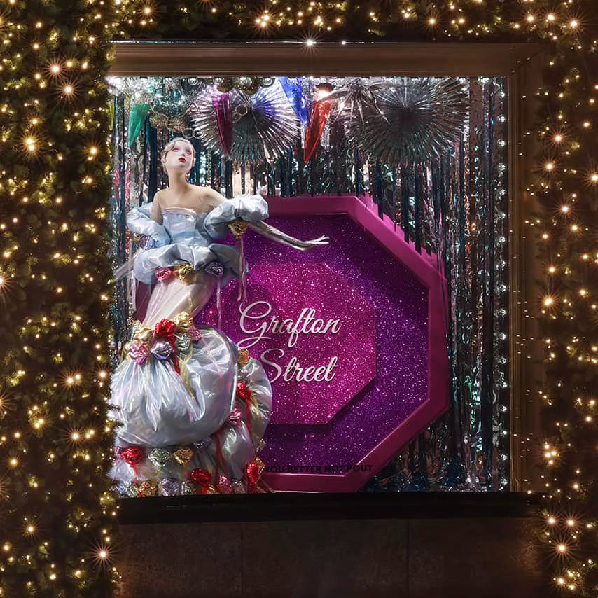 Models surrounding a glittery Christmas tree