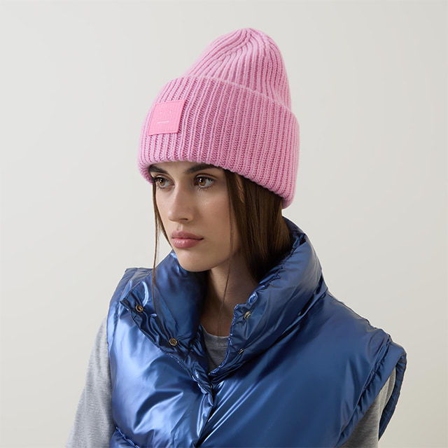 woman in blue winter jacket and pink hat